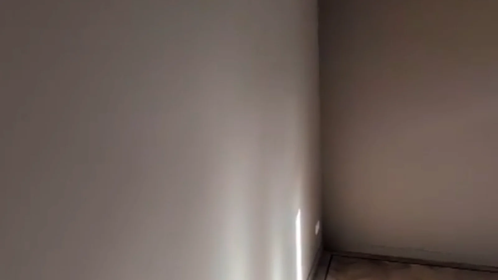 Empty corner of a room with a wooden floor
